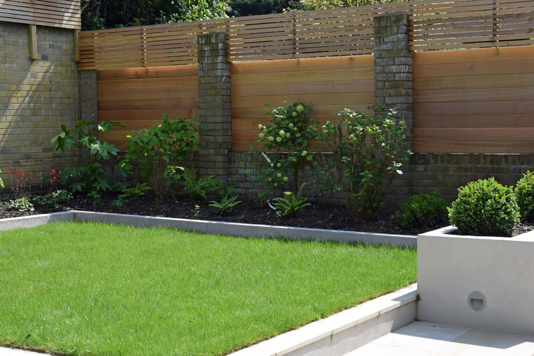 The raised lawn and shady planting